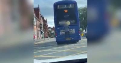 'Welcome to Leigh': Man filmed clinging onto back of bus as it goes down high street - www.manchestereveningnews.co.uk