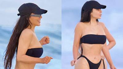 Kim Kardashian flaunts figure in cheeky black bikini during beach outing - www.foxnews.com - California