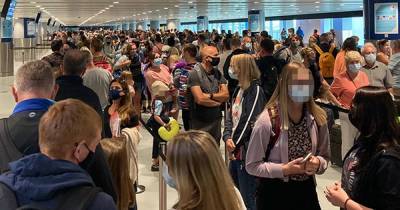 Pictures show huge queues at Manchester Airport's new Terminal 2 - with suitcases piling up on conveyor belts and floors - www.manchestereveningnews.co.uk - Manchester