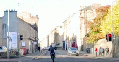 Heart-stopping moment motorbike yob caught running red light and pulling wheelie on Scots street - www.dailyrecord.co.uk - Scotland