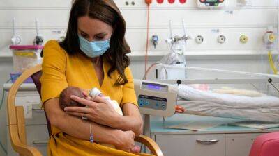 Kate Middleton - queen Elizabeth - Karen Millen - Kate Middleton Holds Newborn Baby and Offers Support to Moms During Visit to Maternity Hospital - etonline.com