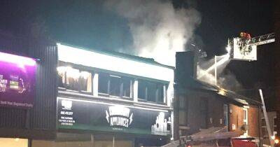 Firefighters wearing breathing gear tackle blaze near row of shops in Stockport - www.manchestereveningnews.co.uk - Manchester