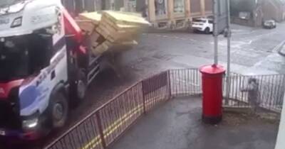 Scots woman's narrow escape caught on CCTV after huge pile of timber plunges off lorry into her path - www.dailyrecord.co.uk - Scotland