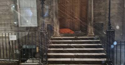 Anger as Scot pictured sleeping in doorway during heavy snow - www.dailyrecord.co.uk - Scotland