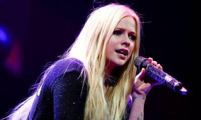 Avril Lavigne poses in thigh-high boots and bralette as she shares new heartbreak - hellomagazine.com - Britain - Malibu