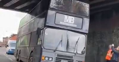 Hours of traffic chaos as unlucky bus driver gets double-decker wedged under bridge - www.manchestereveningnews.co.uk - Britain - Manchester - county Lane