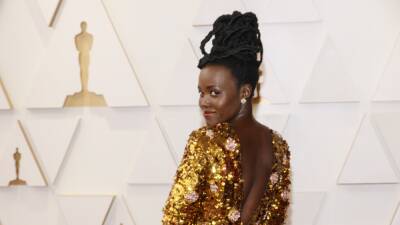 Lupita Nyong - Let's Take a Moment for Lupita Nyong'o's Fishtail Loc Updo at the 2022 Oscars - glamour.com