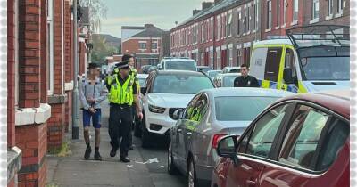 Dozens of police storm homes in Manchester in dawn raids after shooting - www.manchestereveningnews.co.uk - Manchester