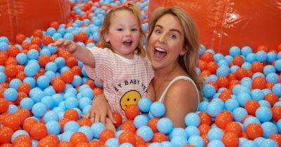 Lydia Bright - Lydia Bright smiles with adorable daughter Loretta as they play at inflatable theme park - ok.co.uk