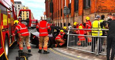 Firefighters descend as purple BMW smashes into side of old Salford hospital - manchestereveningnews.co.uk - Manchester