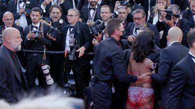 Kyle Buchanan - Zack Sharf - Screaming Woman Removed from Cannes Red Carpet After Crashing George Miller Film Premiere - variety.com