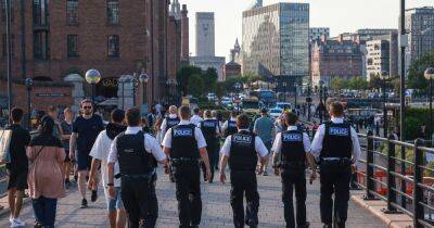 Girl, 13, arrested after police in Liverpool attacked as 'hundreds' gather at docks - www.manchestereveningnews.co.uk