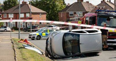 Man in his 80s taken to hospital after being cut from flipped over car in middle of road - www.manchestereveningnews.co.uk - Manchester