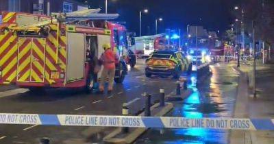 Huge emergency response after car smashes into garage on major road - www.manchestereveningnews.co.uk - Manchester