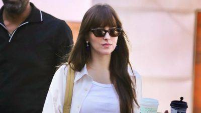 Dakota Johnson Performs Her Godmother Duties in Sheer Shoes and a Freshly Cut Crop Top - www.glamour.com - Los Angeles