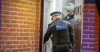 Woman shouts 'who is it' as cops batter down door amid raid on family home - www.dailyrecord.co.uk - Beyond