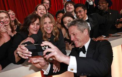 “Uncomfortable” Hugh Grant red carpet interview goes viral at Oscars 2023 - www.nme.com - Britain