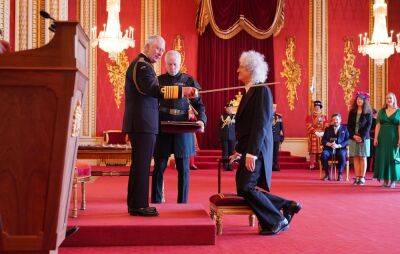 Queen’s Brian May knighted by King Charles at Buckingham Palace - www.nme.com