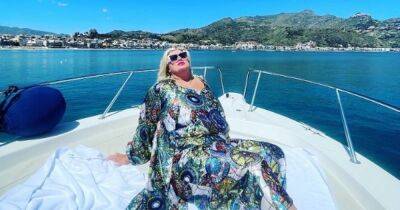 Gemma Collins stuns in plunging black swimsuit as she boogies on boat - www.ok.co.uk - Italy