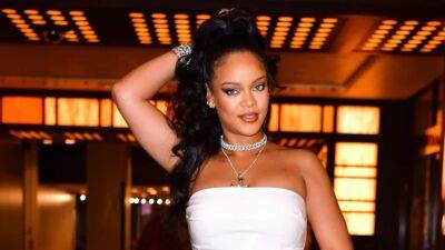 Rihanna Shows Off Baby Bump in All-White Ensemble During Surprise Appearance - www.etonline.com - Britain - state Nevada