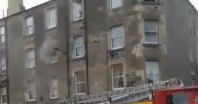 Fire crews race to Edinburgh flat blaze as two rushed to hospital for treatment - www.dailyrecord.co.uk - Scotland - Beyond