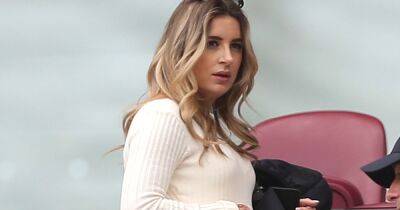 Dani Dyer cradles blossoming baby bump as she watches footie with dad Danny - www.ok.co.uk - Britain