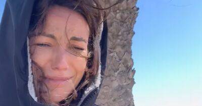 Michelle Keegan looks very unimpressed as she wraps up during windy beach filming - www.ok.co.uk