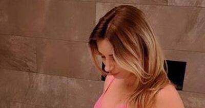 Pregnant Dani Dyer shows off baby bump in pink bikini on 'lovely' family spa day - www.ok.co.uk