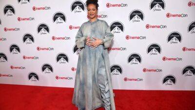 Pregnant Rihanna Makes Surprise Appearance at CinemaCon to Announce Her New 'Smurfs' Role - www.etonline.com - Las Vegas