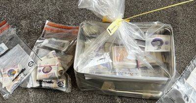 Man and woman arrested after £10k in cash uncovered in raids - www.manchestereveningnews.co.uk - Manchester