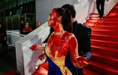 Ukrainian Protester Pulled Off Cannes Red Carpet After Covering Herself in Fake Blood - variety.com - Britain - Ukraine - Russia