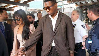 Jonathan Majors Shows Up to Court Holding Hands With Meagan Good, Trial Date Set - www.etonline.com