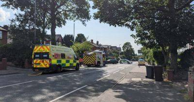 Emergency services block main road as four people left injured in car crash - www.manchestereveningnews.co.uk - Manchester