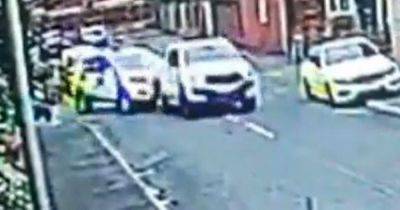 Moment driver 'rams' into police car before speeding off leaving two officers injured - www.manchestereveningnews.co.uk - Manchester