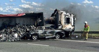 Man 'seriously injured' after crash between lorry and car with both bursting into flames - www.manchestereveningnews.co.uk