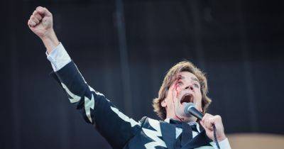 The Hives frontman cuts head open at Arctic Monkeys gig - but carries on singing as blood pours down face - www.manchestereveningnews.co.uk - Sweden - Manchester - Beyond