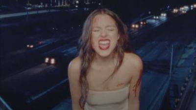 Olivia Rodrigo Is Bloody and on the Run in New 'Vampire' Music Video: Listen to the Breakup Anthem - www.etonline.com