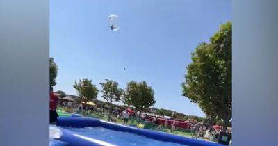 Heartstopping video shows moment boy fell out of the sky in inflatable zorb ball horror - www.manchestereveningnews.co.uk - Manchester