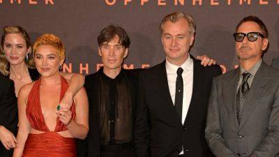 Christopher Nolan Says 'Oppenheimer' Cast Left UK Premiere to 'Write Their Picket Signs' for SAG Strike - www.etonline.com - Britain - USA