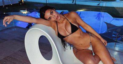 Kim Kardashian Sends Enticing Message With Bikini Thirst Trap: ‘Risk and You Shall Receive’ - www.usmagazine.com