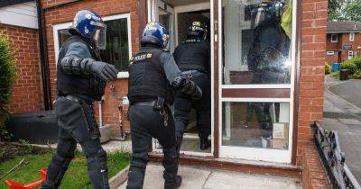 Police storm homes in morning raids in crackdown on 'rival gangs vying for control' - www.manchestereveningnews.co.uk - Manchester - Beyond