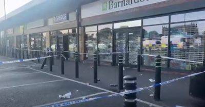Row of shops cordoned off after teen stabbed in the back - www.dailyrecord.co.uk - Beyond