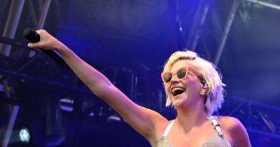 Pregnant Pixie Lott displays blossoming baby bump in backless silver dress for festival - www.ok.co.uk - Britain
