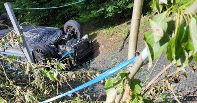 Scot cops hunt 'runaway driver' after smashed up car lands on roof near golf club - www.dailyrecord.co.uk - Scotland - Beyond