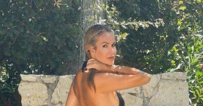 Amanda Holden, 52, flaunts incredible figure with cheeky sideboob in shower snap as she continues sun-soaked break - www.manchestereveningnews.co.uk