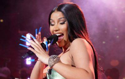 Cardi B throws microphone at audience member who chucked drink at her on stage - www.nme.com - Chicago