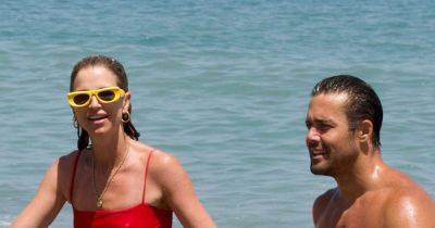 Vogue Williams and Spencer Matthews hold hands and show off toned figures on beach - www.ok.co.uk - Spain - county Spencer