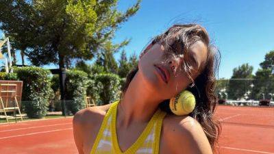 Irina Shayk Serves Least Practical Tennis Look in Thigh-High Flip Flops - www.glamour.com