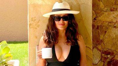 Salma Hayek Perfects the Swimsuit Thirst Trap With a Dangerously Low-Cut Black One-Piece - www.glamour.com - Spain - Mexico