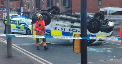 Police van lands on its ROOF as four taken to hospital following crash - www.manchestereveningnews.co.uk - Manchester